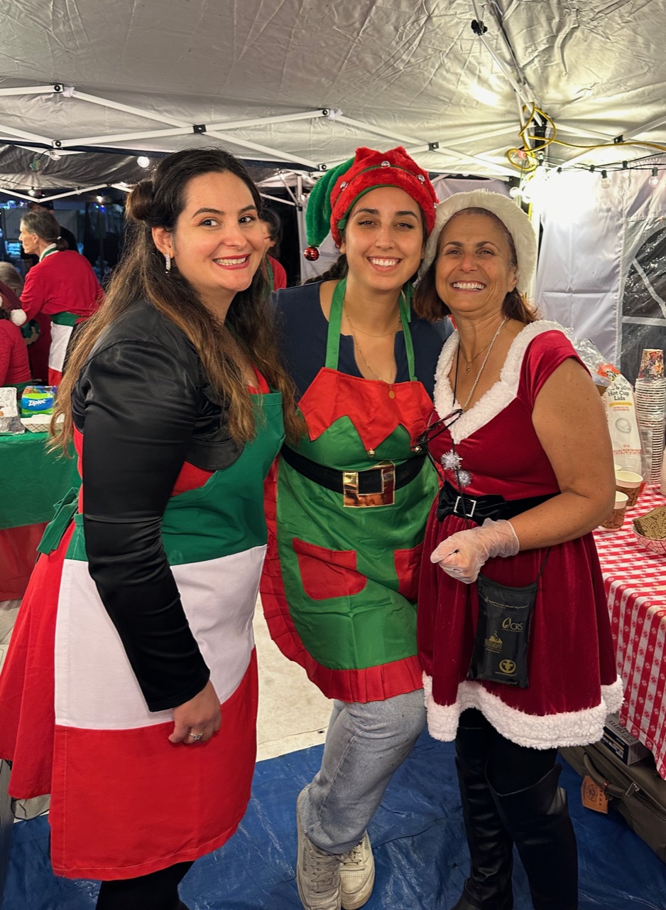 Three ladies in Christmas attire smiling